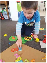 A child learning how to count in hundreds
